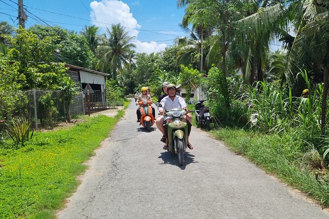 Ben Tre Mekong Zig Zag: Scooter, Sailboat, and Food (Full day) - A quiet sailboat through a coconut-shaded canal