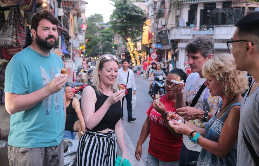 Discover Hanoi's Street Food by Night & Mini Class Coffee - Crossing Hanoi streets with a local guide