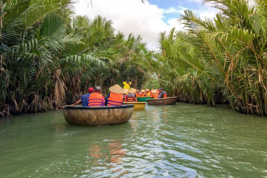 Experience Bamboo Basket Boat on Coconut village w Locals - Putting on the conical hat and boarding the basket boat