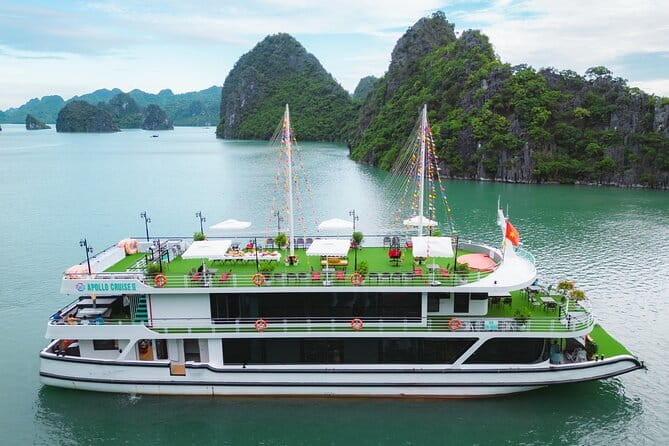 Halong Apollo 5<em> Cruise with Jacuzzi Day Trip And Buffet Lunch – What a $60 Halong Bay day really gives you’ /></p>
<p><p>At $60 per person, this tour is priced as a practical way to see Halong Bay from Hanoi without booking a two-day, one-night cruise. The package includes hotel pickup, an air-conditioned vehicle, the cruise, an English-speaking guide, entrance fees, and an Asian and European buffet lunch.</p>
</p>
<p><p>That is good value if you want the main sights and do not need a cabin or a slow evening on the water. You are paying for access to a full day of transport and activities, not for a quiet escape. The road from Hanoi takes about two and a half hours each way, and the full experience lasts around 12 hours.</p>
</p>
<p><p>I would choose this trip if my time in northern Vietnam were tight. If I had more room in my schedule, I would compare it with an overnight cruise, since staying aboard the bay gives you more unhurried time. Still, Apollo covers a lot in one day.</p>
</p>
<p><p>The 19-person limit also matters. A smaller group can make it easier to hear the guide, move through the port, and keep track of departure times. It does not turn the day into a private tour, but it should feel more manageable than a large coach group.</p>
</p>
<div class="twil" style="margin: 20px 0; padding: 15px 0;"><p>More Ha Long Bay Cruises in Hanoi</p><ul style="margin: 10px 0; padding-left: 0; list-style: none;"><li style="margin: 0 0 12px 0; padding: 0 0 12px 0; border-bottom: 1px solid #FDF4DB; line-height: 1.4;"><a href="https://vietnameseguides.com/hanoi-ha-long-bay-day-cruise-swimming-meal-kayaking/">Hanoi: Ha Long Bay Day Cruise – Swimming, Meal, Kayaking</a><br><span style="font-size: 0.82em; color: #555;"><span style="color: #F0AD00;">★</span> 4.7 &nbsp;&middot;&nbsp; 7,415 reviews</span></li><li style="margin: 0 0 12px 0; padding: 0 0 12px 0; border-bottom: 1px solid #FDF4DB; line-height: 1.4;"><a href="https://vietnameseguides.com/amanda-cruise-ha-long-lan-ha-bay-all-inclusive-2d1n-3d2n/">Amanda Cruise – Ha Long, Lan Ha Bay – All Inclusive 2D1N & 3D2N</a><br><span style="font-size: 0.82em; color: #555;"><span style="color: #F0AD00;">★</span> 5.0 &nbsp;&middot;&nbsp; 4,358 reviews</span></li><li style="margin: 0; padding: 0; border-bottom: none; line-height: 1.4;"><a href="https://vietnameseguides.com/cozy-bay-halong-5-star-day-cruise-buffet-cave-kayak-swimming/">Cozy Bay Halong 5-Star Day Cruise, Buffet, Cave, Kayak, Swimming</a><br><span style="font-size: 0.82em; color: #555;"><span style="color: #F0AD00;">★</span> 5.0 &nbsp;&middot;&nbsp; 3,512 reviews</span></li></ul></div><h2>Leaving Hanoi for Tuan Chau Island</h2>
<p> Cruise with Jacuzzi Day Trip And Buffet Lunch – Leaving Hanoi for Tuan Chau Island’ /></p>
<p><p>The day begins in Hanoi, with pickup from the Hoan Kiem area and nearby hotels. Pickup can take about 45 minutes as the vehicle collects people from different addresses, so I would keep your morning flexible rather than planning anything close to departure.</p>
</p>
<p><p>The drive to Halong Bay takes about two and a half hours, with the full Hanoi portion listed at roughly three hours. This is the least exciting part of the day, but it is the unavoidable price of visiting the bay from the capital.</p>
</p>
<p><p>The included vehicle is air-conditioned, and one detailed account describes the ride as a comfortable limousine-style minibus. That makes a real difference on a road-heavy outing. Your guide uses the journey to explain the day and give instructions, which helps you know when to return to the boat after each stop.</p>
</p>
<p><p>Tuan Chau Island is the main port for the cruise. Once there, the group has time to rest while the guide handles ticket arrangements before you board. The island itself is more of a transport hub than a major sightseeing stop, so do not expect the port visit to be a highlight.</p>
</p>
<p><p>Lunch is served aboard the boat after boarding. Since drinks are not included, check the onboard prices before ordering. The buffet includes both Asian and European-style dishes, a sensible setup for a mixed group with different tastes.</p>
</p>
<h2>Six hours among Halong Bay’s limestone islands</h2>
<p><img width="669" height="446" decoding="async" src=