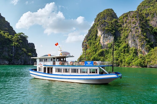 Halong Bay Day Tour With Titop Island, Cave, Kayak & Lunch - Boarding at Tuan Chau Island and cruising past the limestone islets