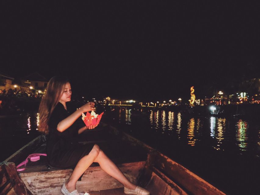Hoi An: Night Boat Trip and Release Lantern at Hoai River - Releasing a paper lantern for luck and peace