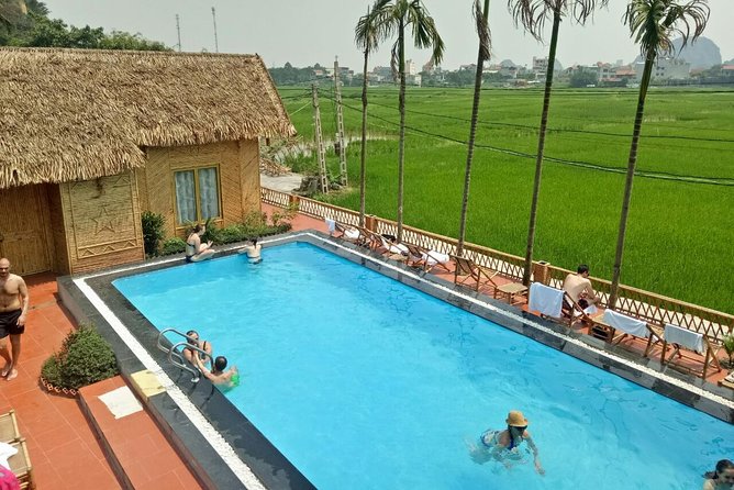 Ninh Binh Daily Tour: Hoa Lu -Mua Cave -Tam Coc- Bike-Swimming with Sunset Party - Tam Coc by sampan, the day’s calm center