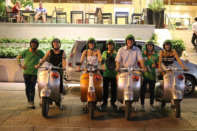 Saigon After Dark Vespa Street Food Tour + Live Music 4 hours - Saigon after dark, seen from a moving Vespa